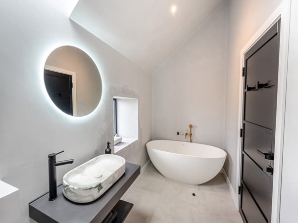 Microcement master ensuite with freestanding bath