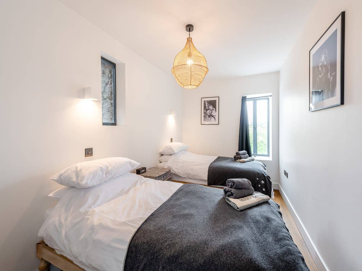 Twin bedroom with rattan pendant