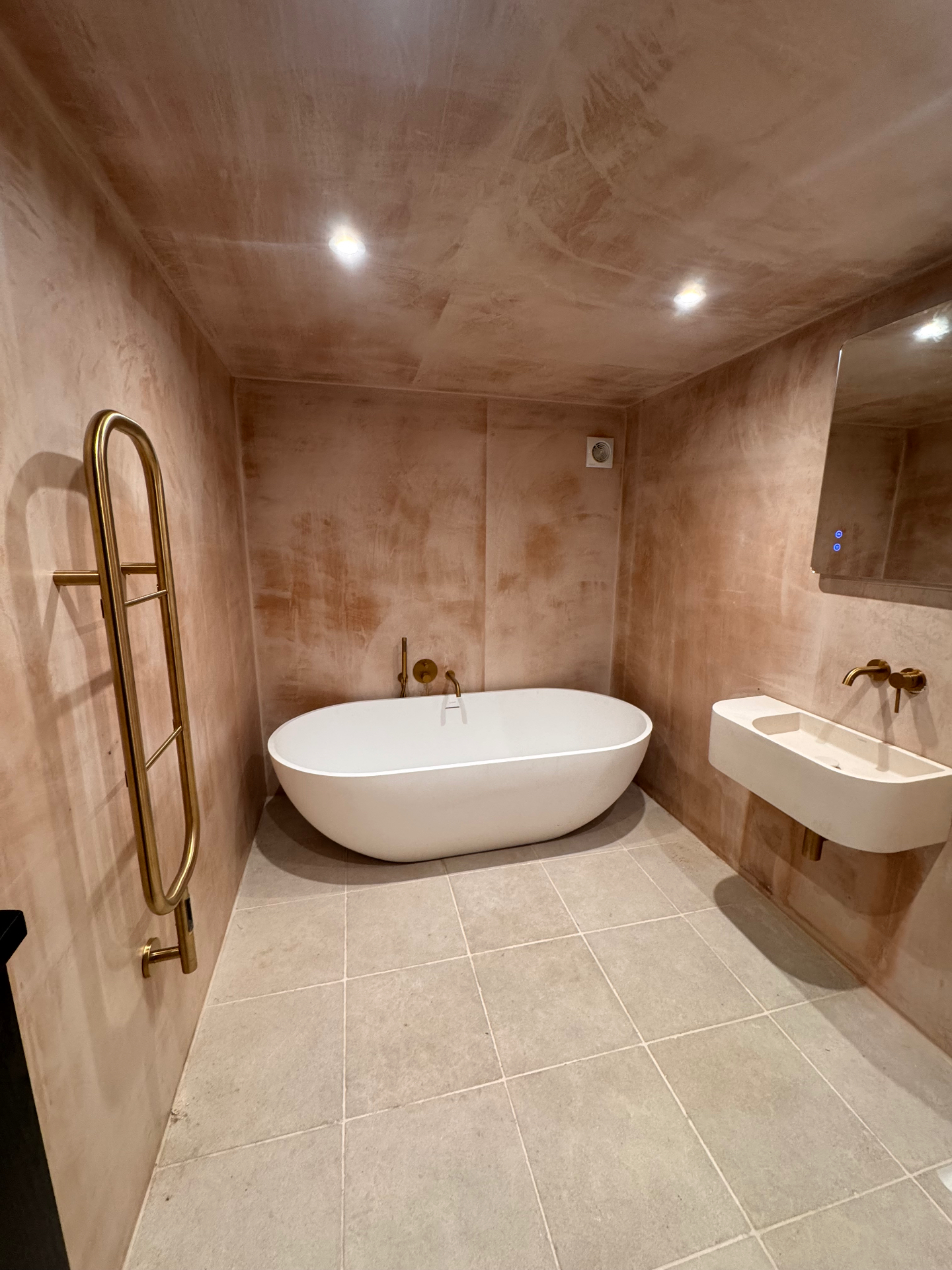 Bathroom with freestanding tub and brass fittings