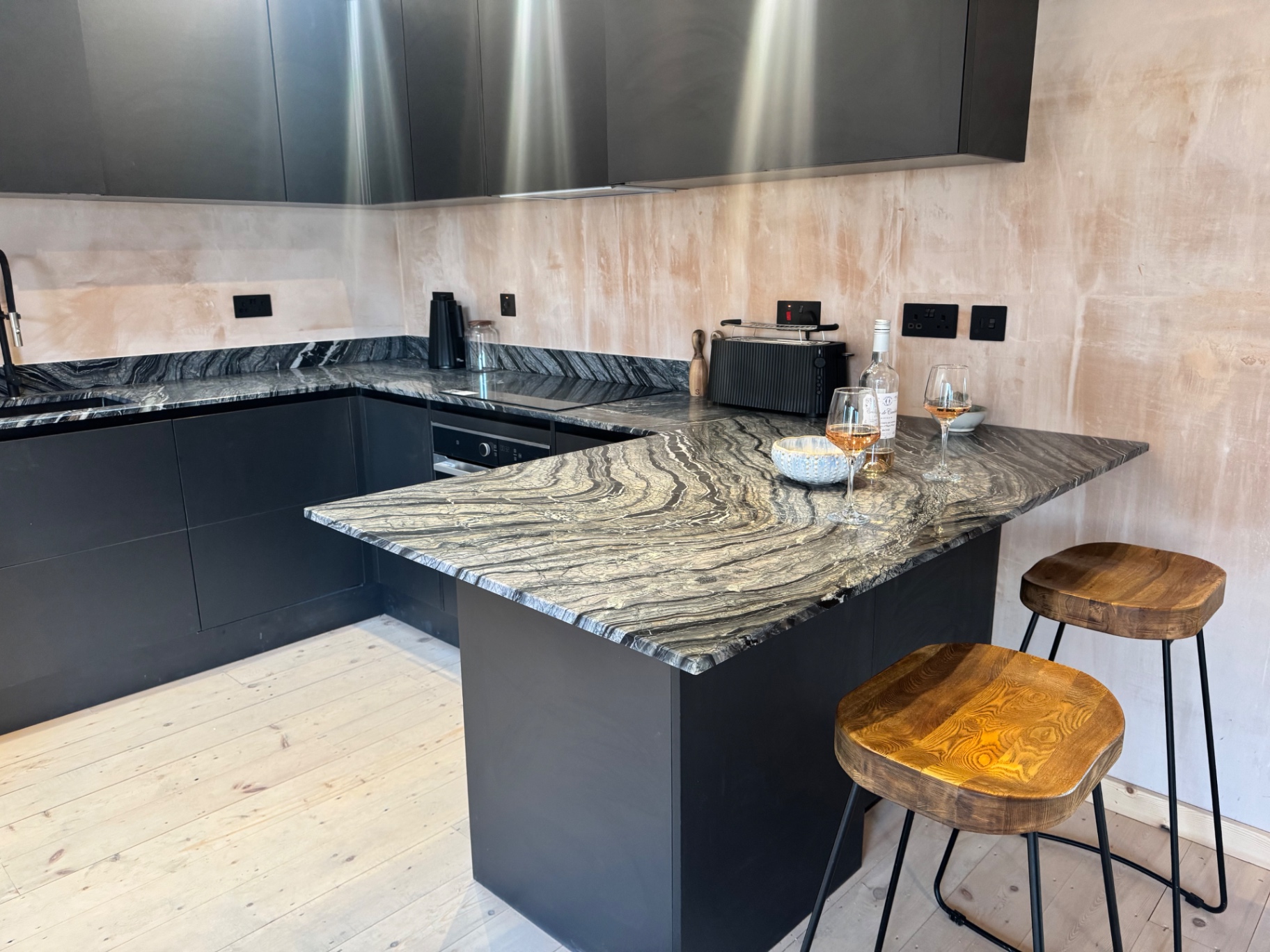 Black kitchen with marbled stone counter
