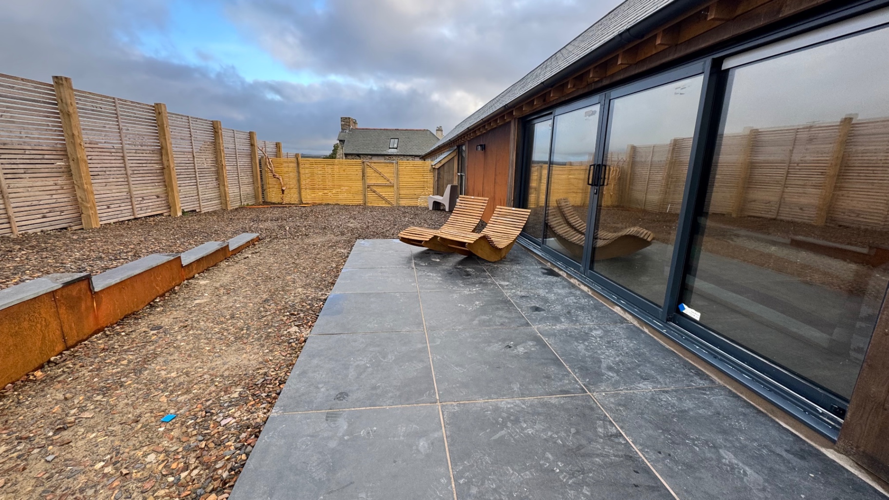 Upper Berry Lodge slate patio with loungers